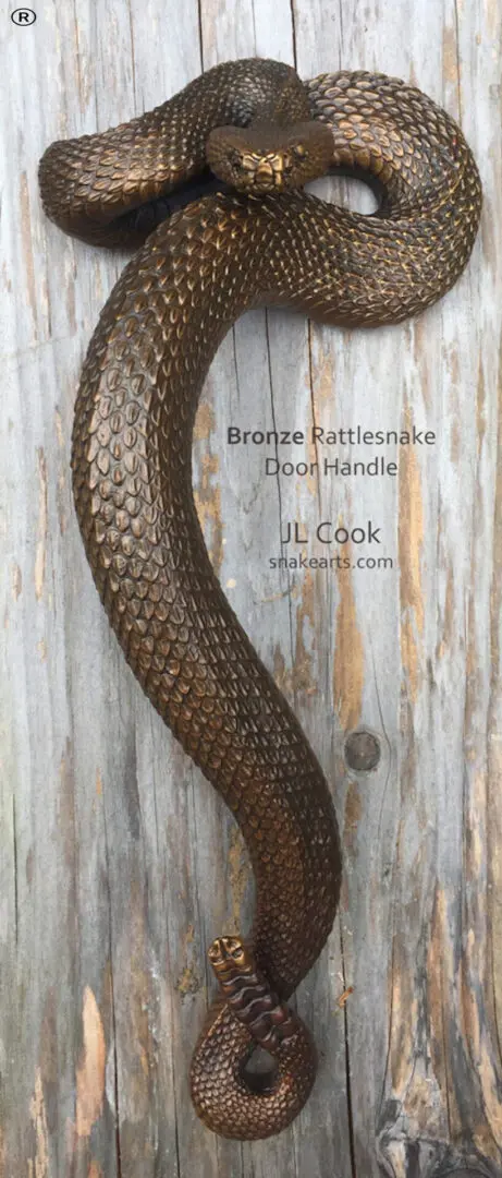 A rattlesnake sculpture on a wooden surface